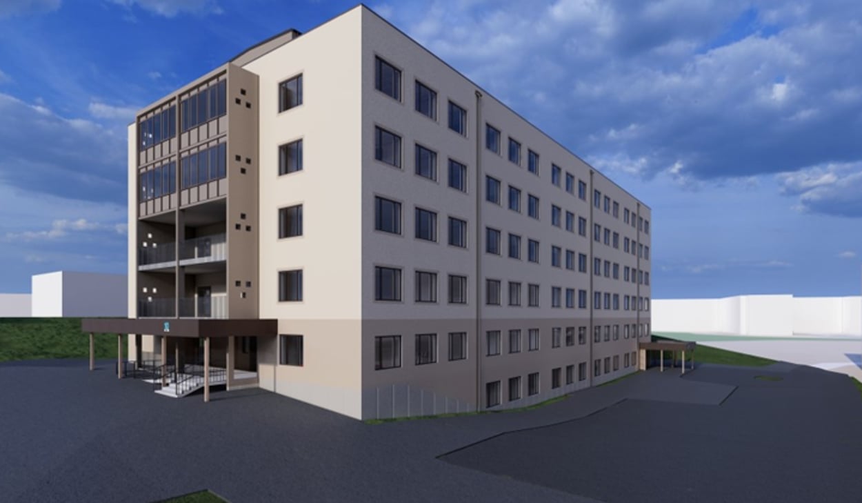 En arkitektrendering av hus 10 på Hudiksvalls sjukhus som det kommer att se ut efter ombyggnation. Byggnaden har fem våningar över mark. Fasaden är ljus och över entrén på kortsidan finns balkonger. 